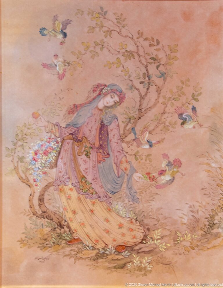 Miniature-style painting of a woman bending among flowers beneath a flowering tree, with small birds in the branches.