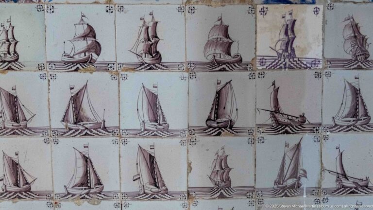 Rows of pale ceramic tiles decorated with repeated sailing ships, showing masts, sails, rigging, and varied hull profiles.