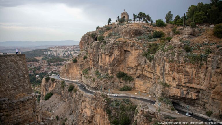 Road and tunnel cut into Constantine’s sheer gorge wall below the hilltop Monument aux Morts.