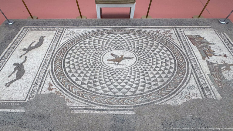 Mosaic of the Eagle of Jupiter with a circular geometric field, central eagle medallion, and rectangular figural side panels.