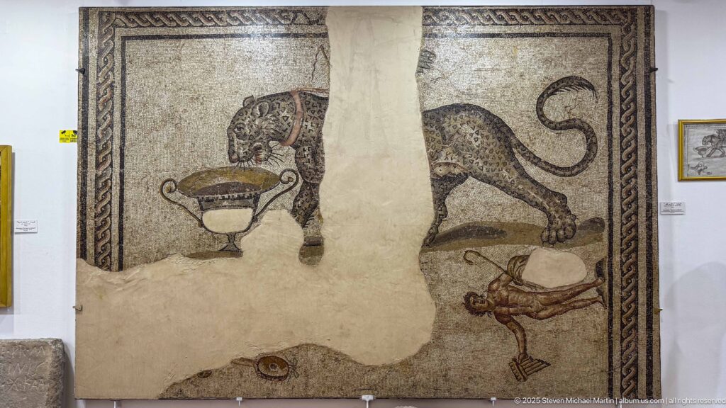 Upper register of the Bacchic Panther mosaic with a large panther approaching a wine krater amid extensive losses.