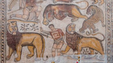 Detail of the Great Hunt Mosaic with two hunters, lions, a spotted leopard, and other wild animals.