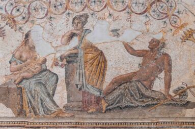 Detail of the Djemila Bacchus Mosaic with a seated woman, standing draped woman, and reclining male figure.