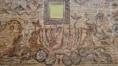 Toilet of Venus Mosaic with Venus seated in a shell holding a mirror, flanked by Tritons and marine figures.