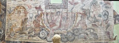 Central detail of the Toilet of Venus Mosaic showing Venus in a shell with a mirror and surrounding marine figures.