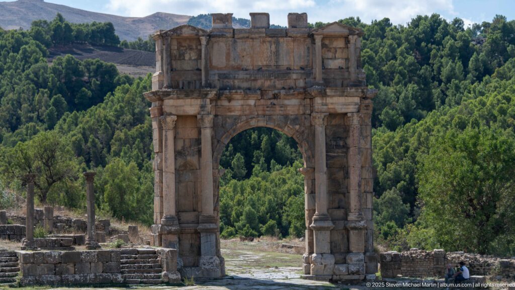 Freestanding Roman triumphal arch with large central opening and paired columns at Djemila.