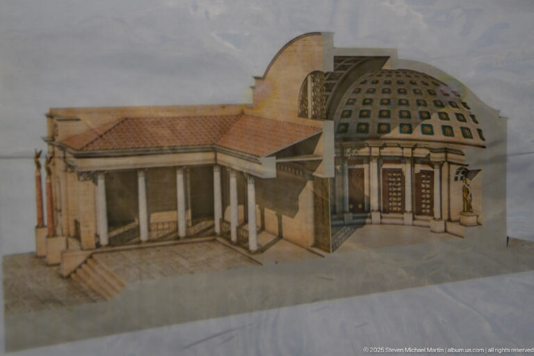 Architectural reconstruction model with a columned entrance and cutaway domed interior.