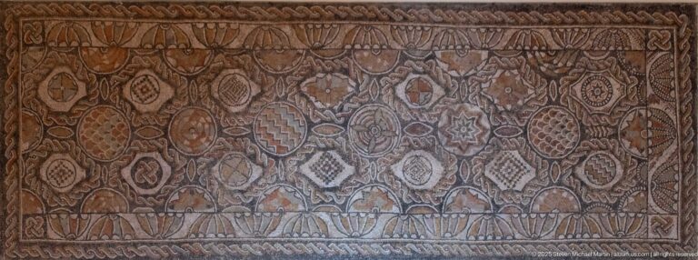 Roman mosaic panel with rows of circular, diamond, and star-shaped compartments filled with varied patterns.