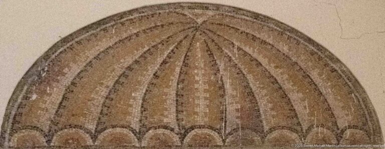 Semicircular Roman mosaic motif with long radiating ribs and rounded scalloped segments along the base.