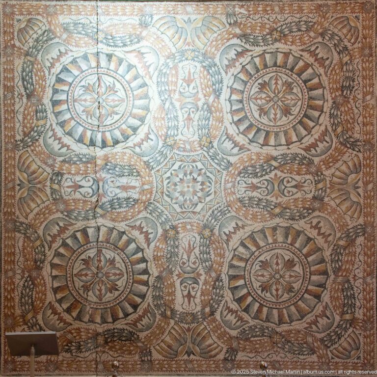 Large polychrome mosaic with circular medallions, floral rosettes, scrolling foliage, and dense geometric ornament.