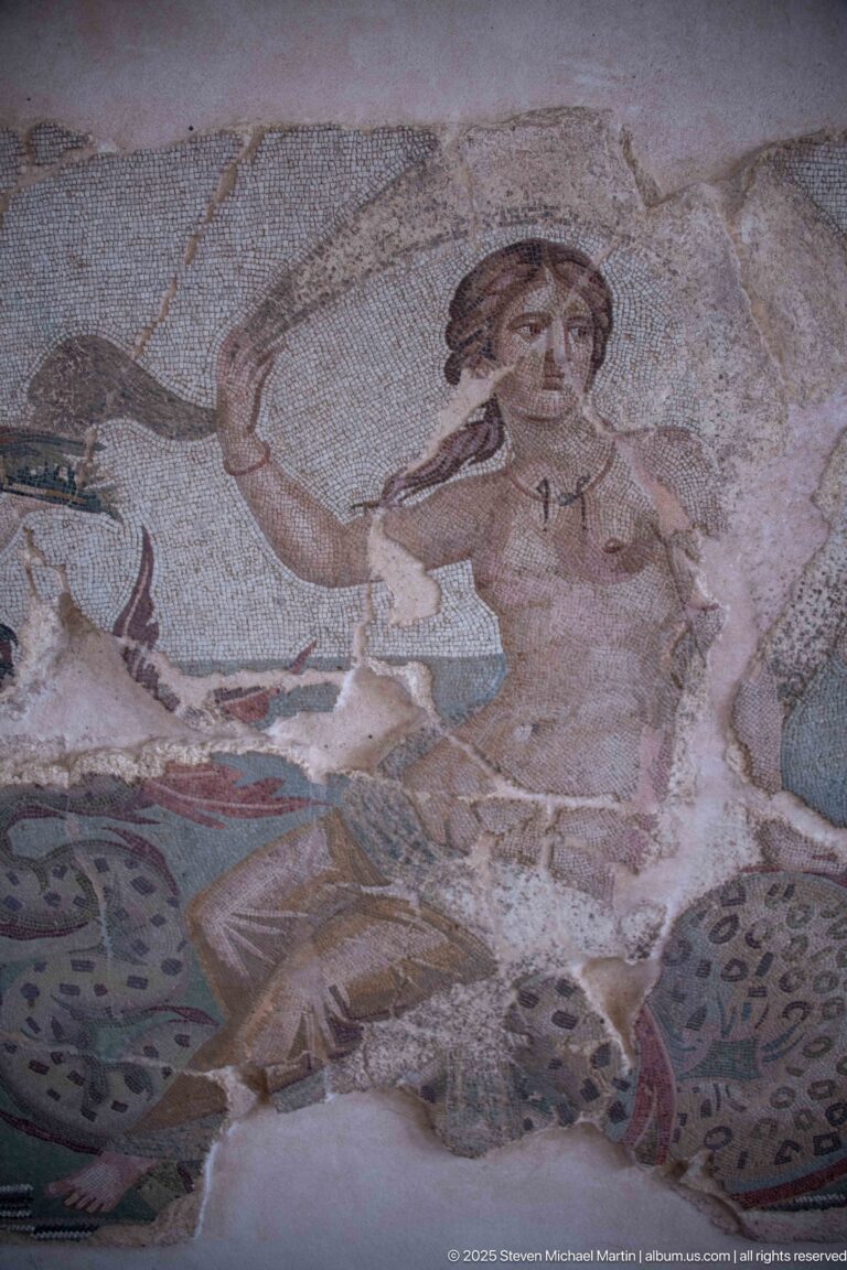 Nereid raising one hand amid fragmentary sea monsters in Aspasios's mid-2nd-century mosaic.