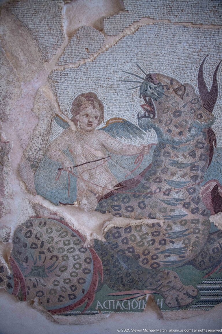 Winged Cupid beside a spotted marine monster in the Mosaic of the Nereids by Aspasios.