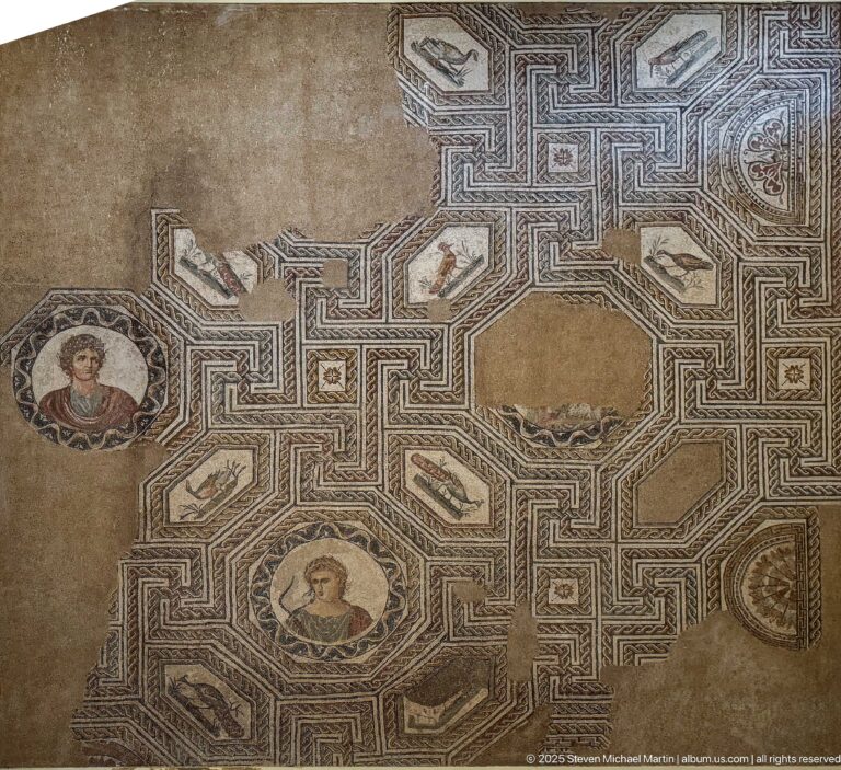 Detail of a Roman mosaic with angular geometric bands, circular portrait medallions, small motifs, and areas of loss.