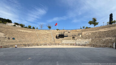 View from the performance area toward the broad semicircular stone seating of the Roman Theatre of Carthage.