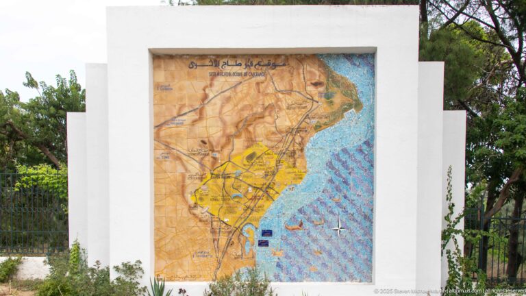 Outdoor visitor map of the Antonine Baths archaeological park showing paths, ruins, shoreline, and surrounding streets.