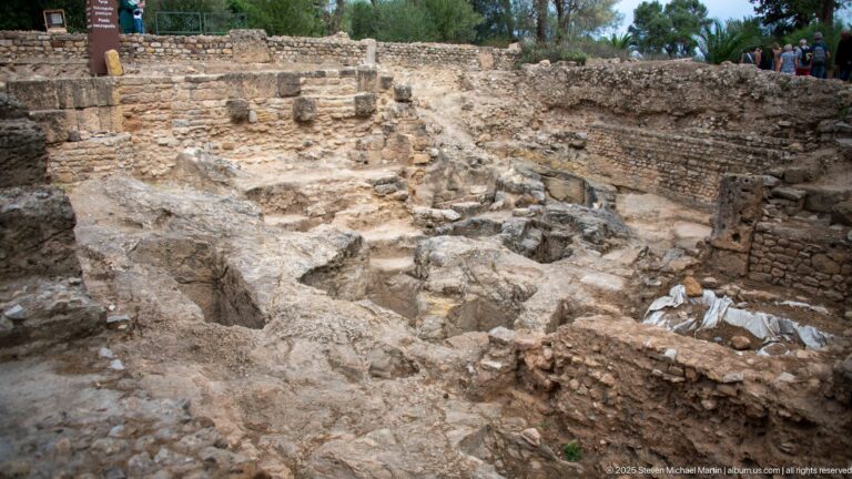 Excavated rock-cut burial pits and low masonry in the archaic Phoenician necropolis at Carthage.