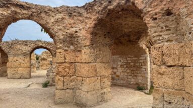 Series of rounded arches and thick stone piers forming connected chambers in the Baths of Antoninus.