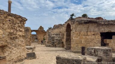 Passage between massive masonry walls and vaulted chambers inside the ruins of the Baths of Antoninus.