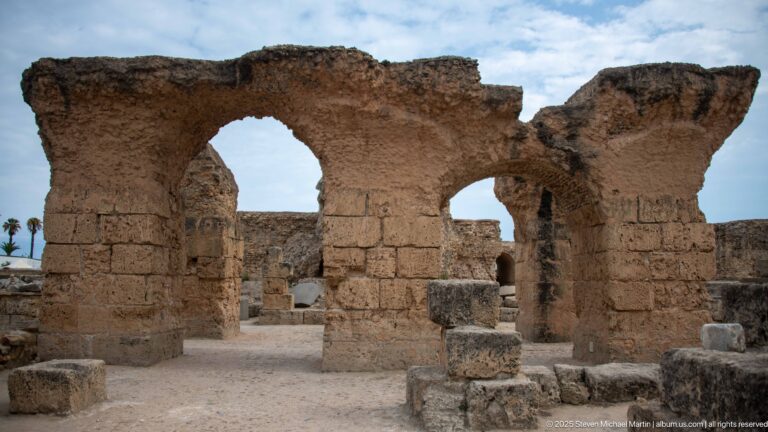 Two large adjoining Roman arches supported by massive masonry piers in the Baths of Antoninus.