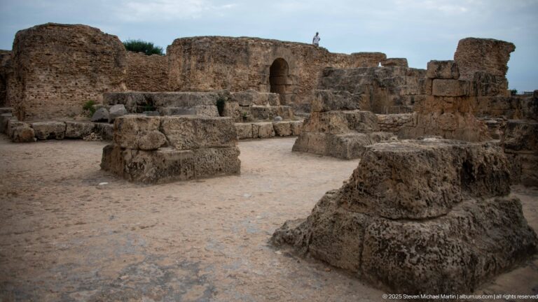 Massive squared stone bases and low piers arranged across an open area of the Baths of Antoninus.