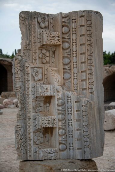 Large carved marble fragment with egg-and-dart, bead-and-reel, rosettes, and geometric classical moldings.