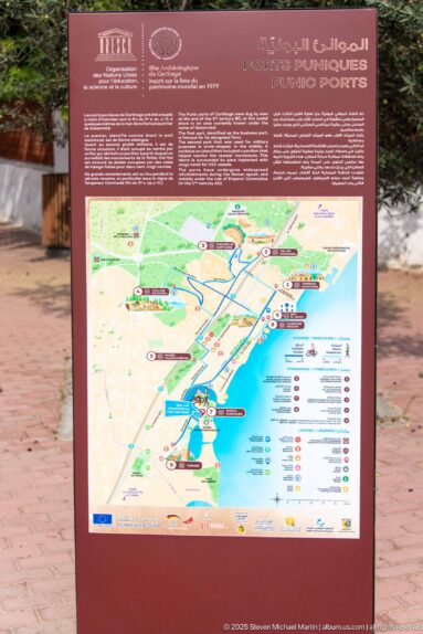 Interpretive panel with a map of the Punic Ports area, archaeological sites, shoreline, roads, and visitor routes.
