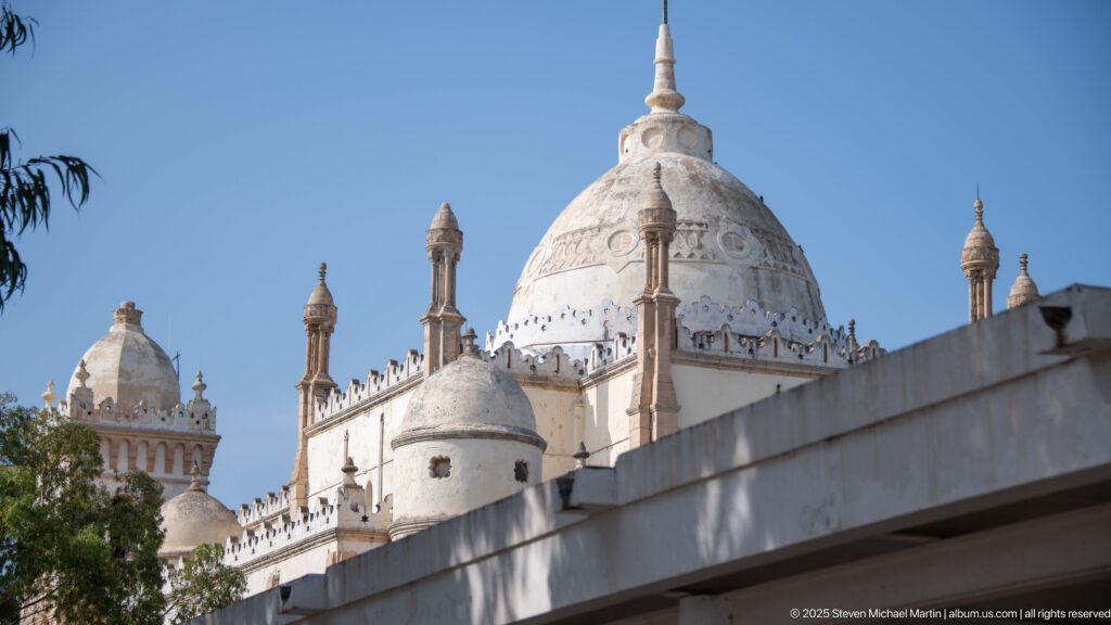 Side view of Carthage L’Acropolium showing a large pale dome, smaller domes, pinnacles, and ornamental roofline.