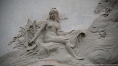 Seated female relief with a lyre, drapery, and sculpted foliage on the Municipal Theatre of Tunis façade.