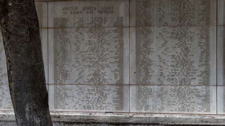 Large pale stone memorial panels densely engraved with names beneath the United States Army and Army Air Forces heading.