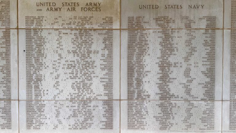 Large stone memorial panels densely engraved with names under Army, Army Air Forces, and United States Navy headings.