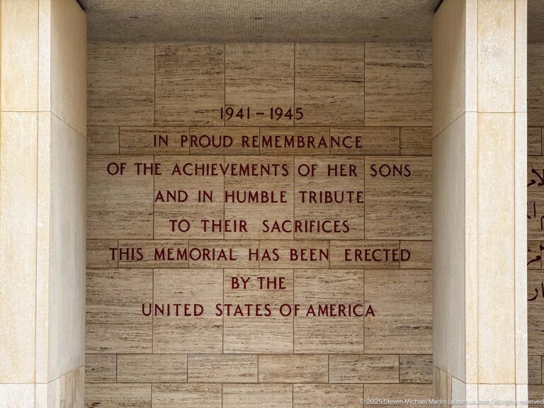 English 1941–1945 memorial dedication centered between pale stone columns.