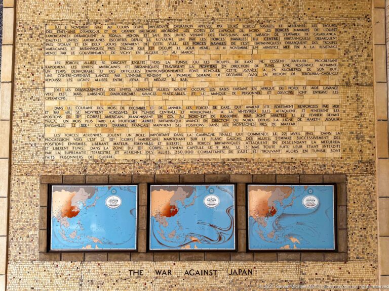 Three framed Pacific-war maps beneath a dense historical text panel labeled The War Against Japan.