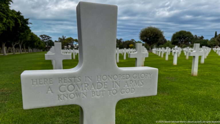 White Latin-cross headstone inscribed Here rests in honored glory a comrade in arms known but to God.