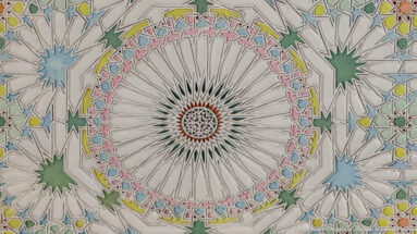 Radial white ceiling medallion surrounded by pink, yellow, green, blue, and turquoise geometric star patterns.