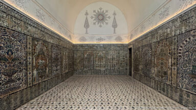 Small Bardo Museum chamber with densely tiled walls, patterned floor, pale vault, and a centered decorative medallion above.