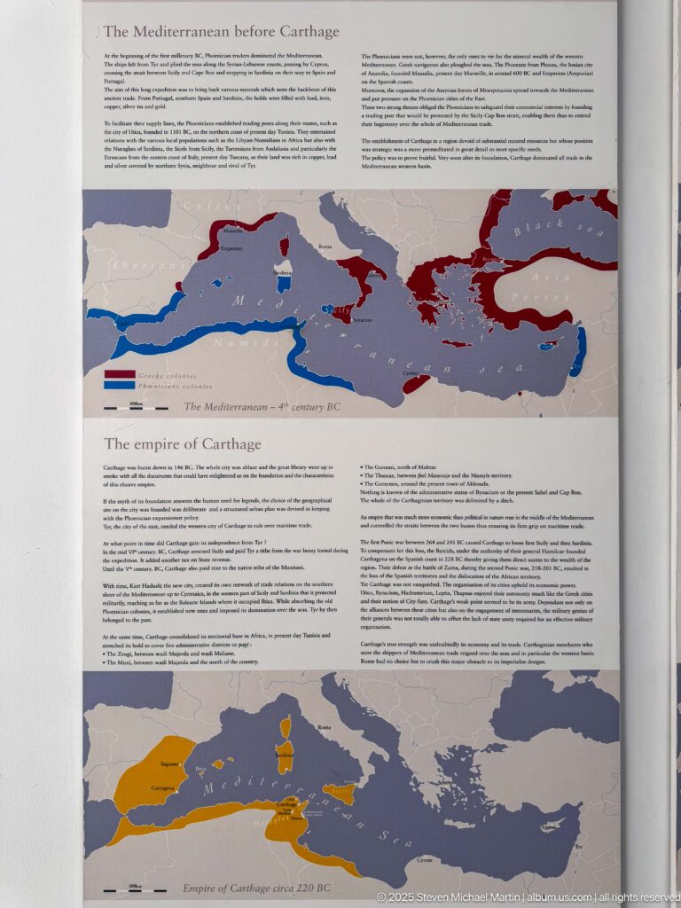 Museum panel with Mediterranean maps showing the origins and territorial expansion of Carthage in contrasting colors.