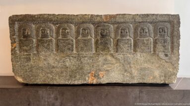 Numidian stele dated about 200–46 BCE with a row of frontal divine busts carved across its upper register.