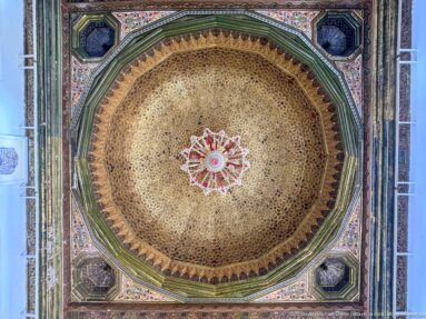 Full octagonal palace ceiling with dense golden ornament, painted borders, corner compartments, and a chandelier at center.