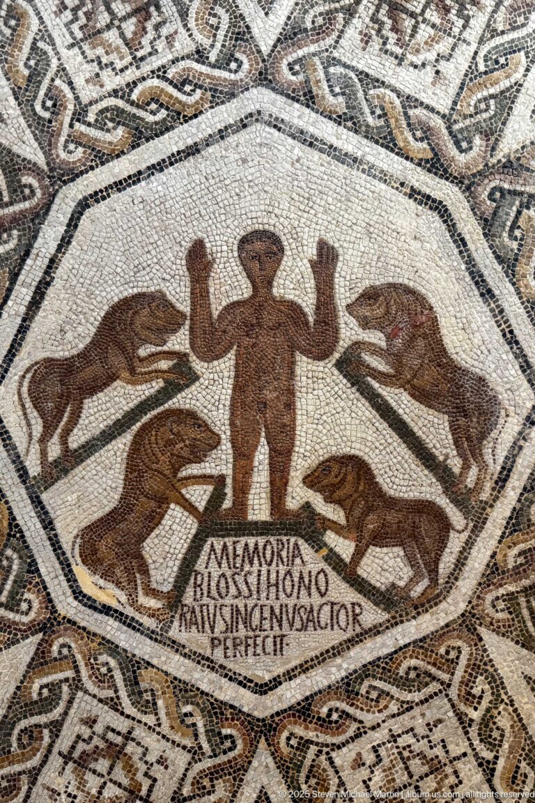 Octagonal Roman mosaic with central standing figure, four surrounding animals, geometric frame, and Latin inscription beginning MEMORIA.