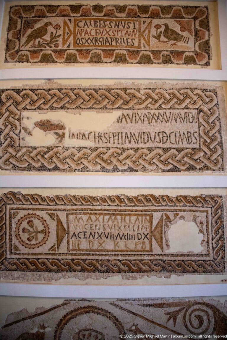 Stacked horizontal Christian mosaic inscriptions with Latin text and braided, geometric, and linear borders.