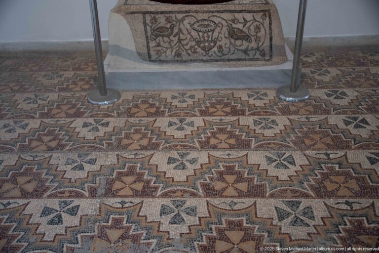 Late Antique floor mosaic with repeating stepped stars, rosettes, polygons, and multicolored geometric bands.