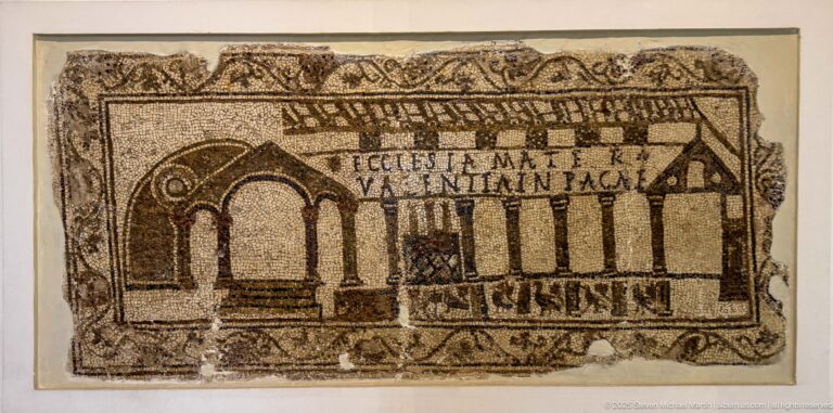 Christian mosaic with stylized colonnaded architecture, arches, Latin inscription, and vegetal border.