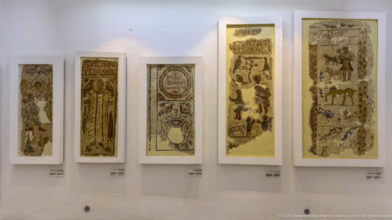 Five tall Christian funerary mosaics displayed in a row with figures, inscriptions, vessels, wreaths, and symbolic imagery.