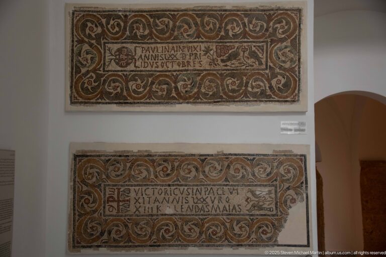 Two horizontal Christian mosaic inscriptions with Latin text and elaborate scrolling vine borders mounted one above the other.