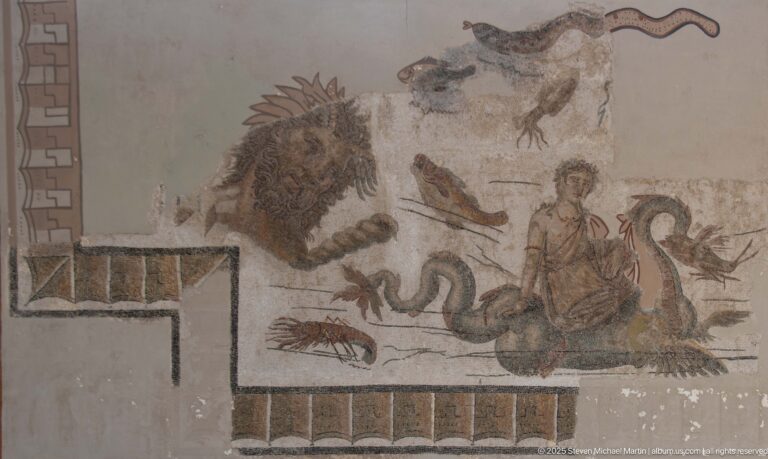 Seated woman in a Roman mosaic surrounded by a lion, coiling snake, crustacean, fish, and other animals.