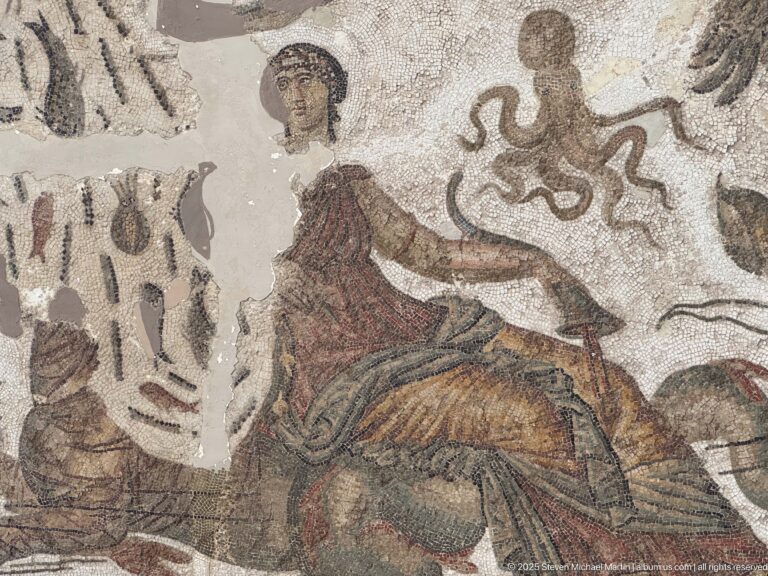 Seated woman in a Roman mosaic holding an octopus above her hand, with fragmentary motifs around her.