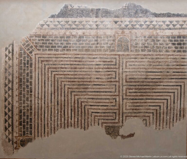 Large geometric mosaic of nested right-angled bands with patterned upper border and substantial losses along the lower field.