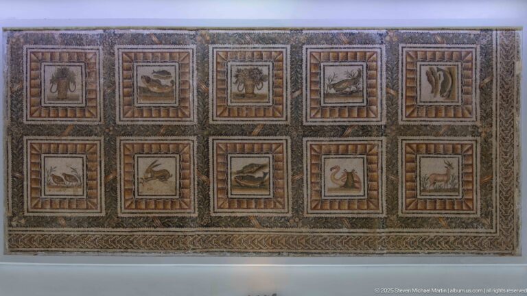 Rectangular Roman mosaic with ten framed panels containing individual animals and birds in two rows.
