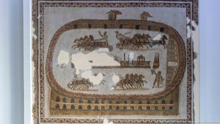 Roman circus mosaic with four-horse chariot teams racing around an elongated track and central spina.