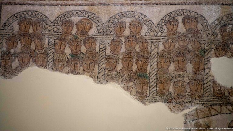 Fragmentary Roman mosaic with many individualized human heads arranged in rows beneath arches and slender columns.